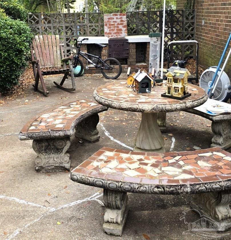 8246 Chellie Road Pensacola, FL 32526 - Photo 18 of 20 a view of a backyard with table and chairs