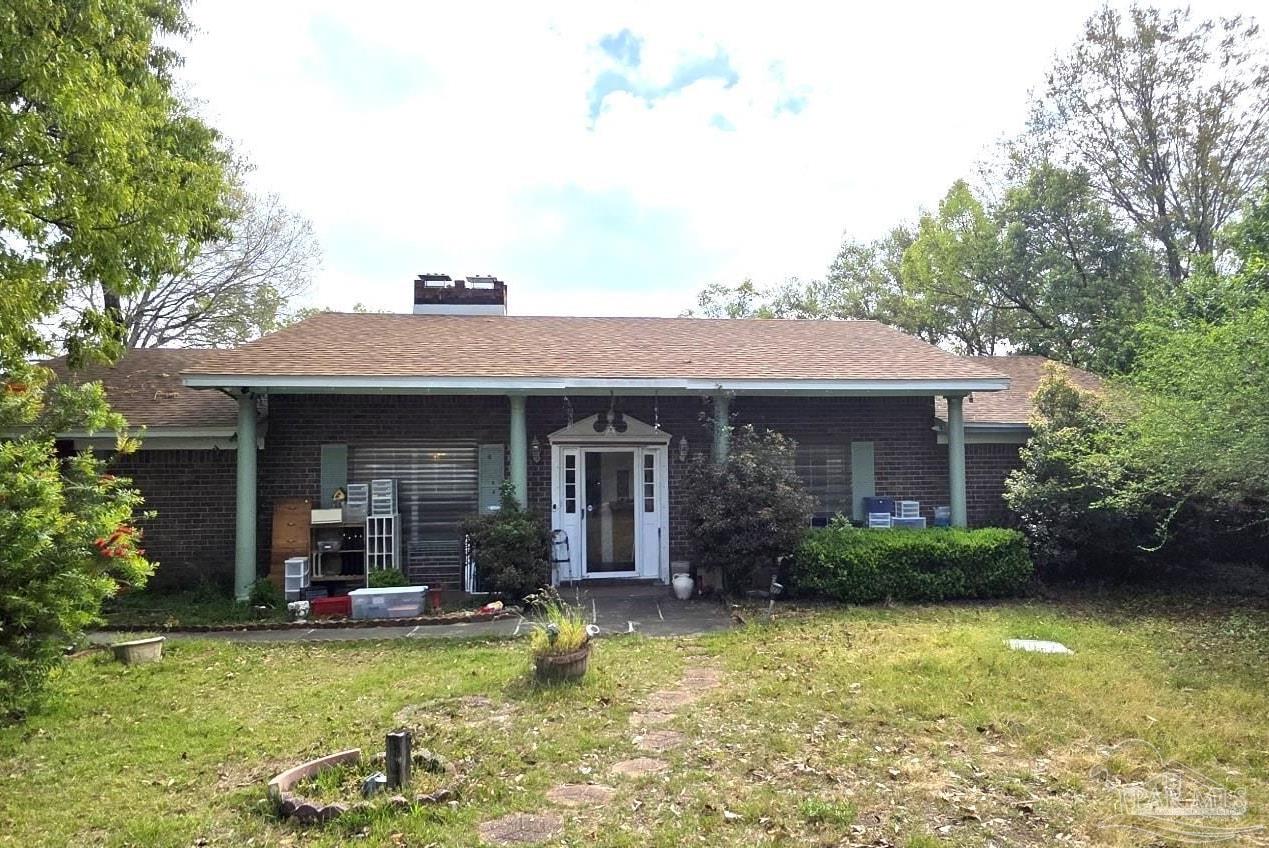8246 Chellie Road Pensacola, FL 32526 - Photo 4 of 20 a view of a house with swimming pool and furniture