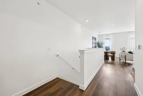 a view of a room with wooden floor and furniture