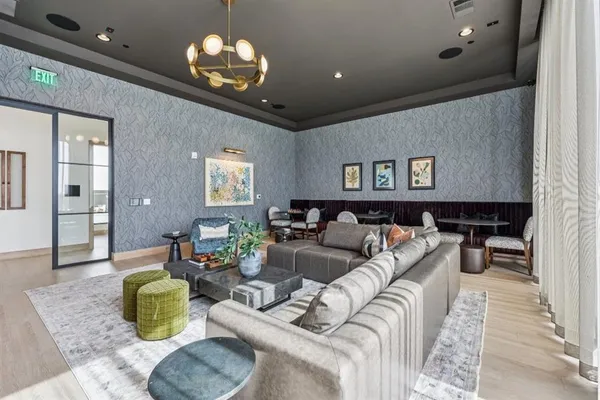 a living room with furniture and a chandelier