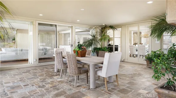 a dining room with furniture and window in it