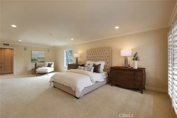 a spacious bedroom with a bed and window