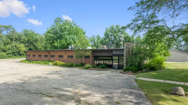 a front view of a house with a yard and a garage