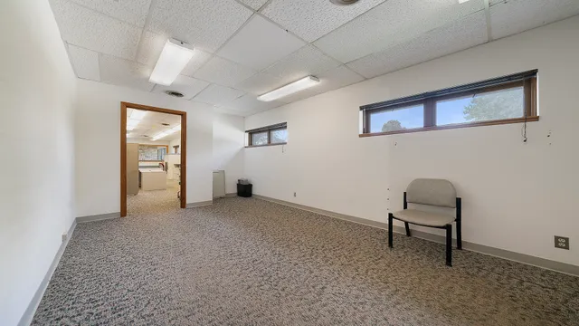 a view of a livingroom with furniture and a window