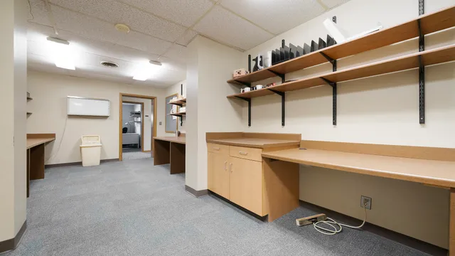 a kitchen that has a lot of cabinets in it and wooden floors