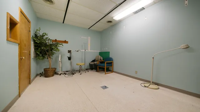 a view of a livingroom with furniture and a bookshelf