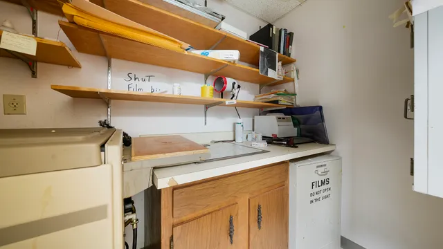 a kitchen with granite countertop a sink cabinets and stainless steel appliances