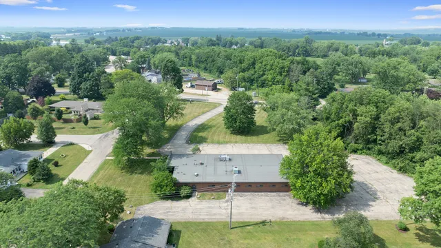 an aerial view of a house with yard and mountain view in back