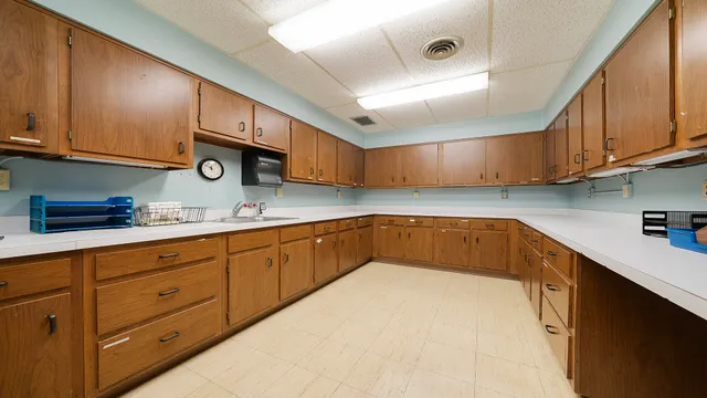 a living room with table chairs and a wooden floor