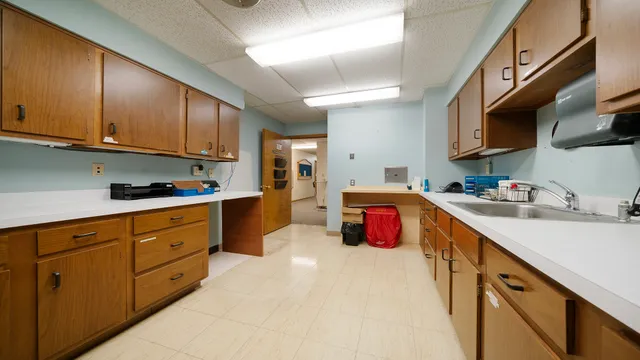 a view of a hallway with a cabinet and mirrors
