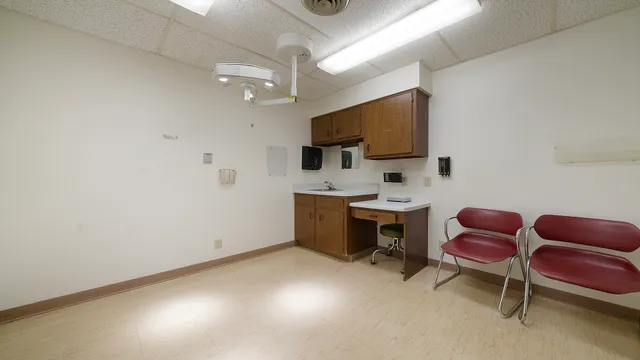 a view of a kitchen with a sink refrigerator and cabinets