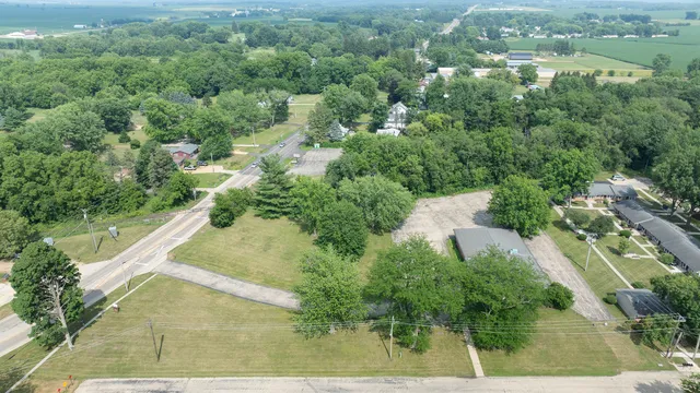 an aerial view of residential houses with outdoor space and trees