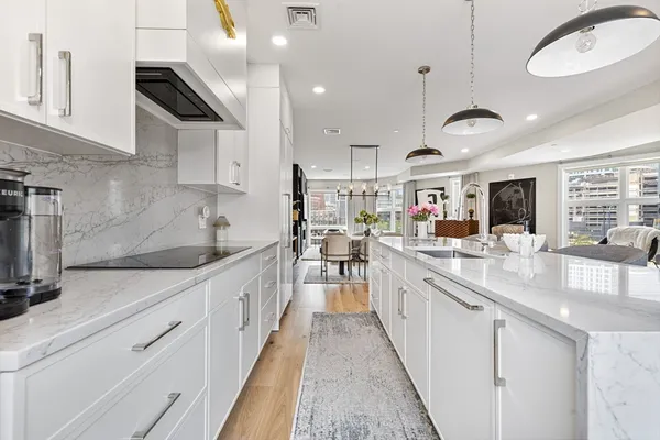 a large kitchen with stainless steel appliances lots of counter space and a sink