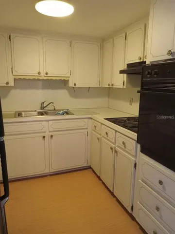 a kitchen with white cabinets
