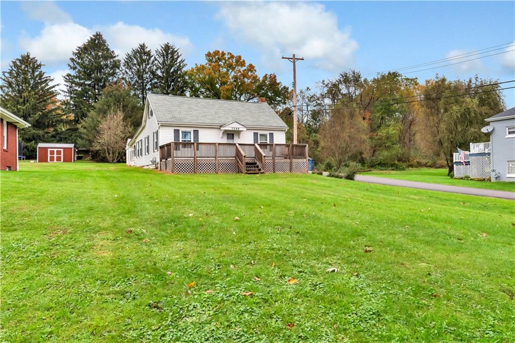 1299 Harvey Run Road Freedom, PA 15042 - Photo 2 of 25 a view of a house with a big yard and large trees