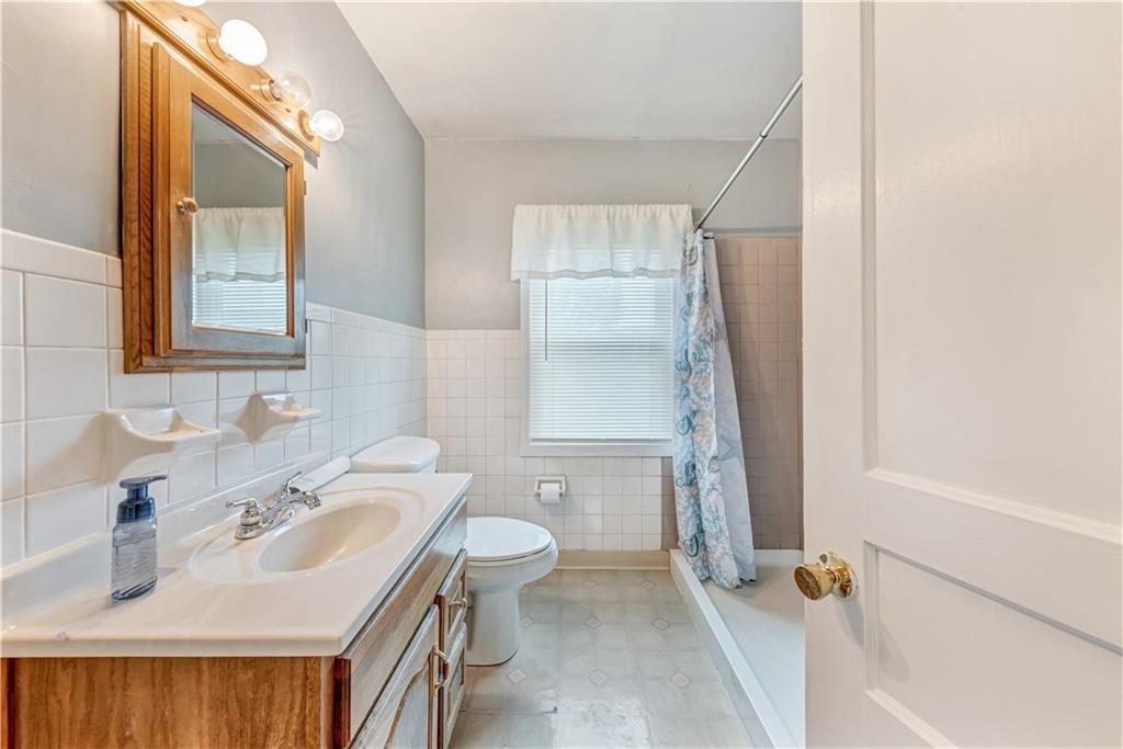 1299 Harvey Run Road Freedom, PA 15042 - Photo 11 of 25 a bathroom with a sink a toilet and shower