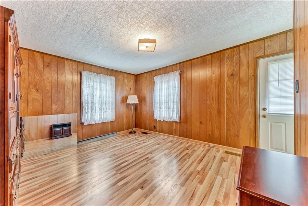 1299 Harvey Run Road Freedom, PA 15042 - Photo 13 of 25 a view of an empty room with a window and wooden floor