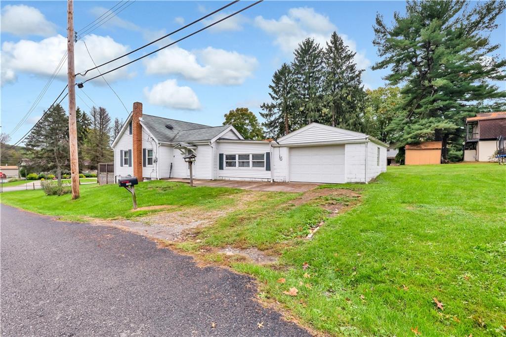1299 Harvey Run Road Freedom, PA 15042 - Photo 24 of 25 a view of house with garden and tall trees