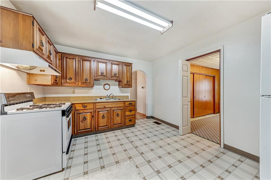 1299 Harvey Run Road Freedom, PA 15042 - Photo 5 of 25 a kitchen with stainless steel appliances a stove a sink and a refrigerator