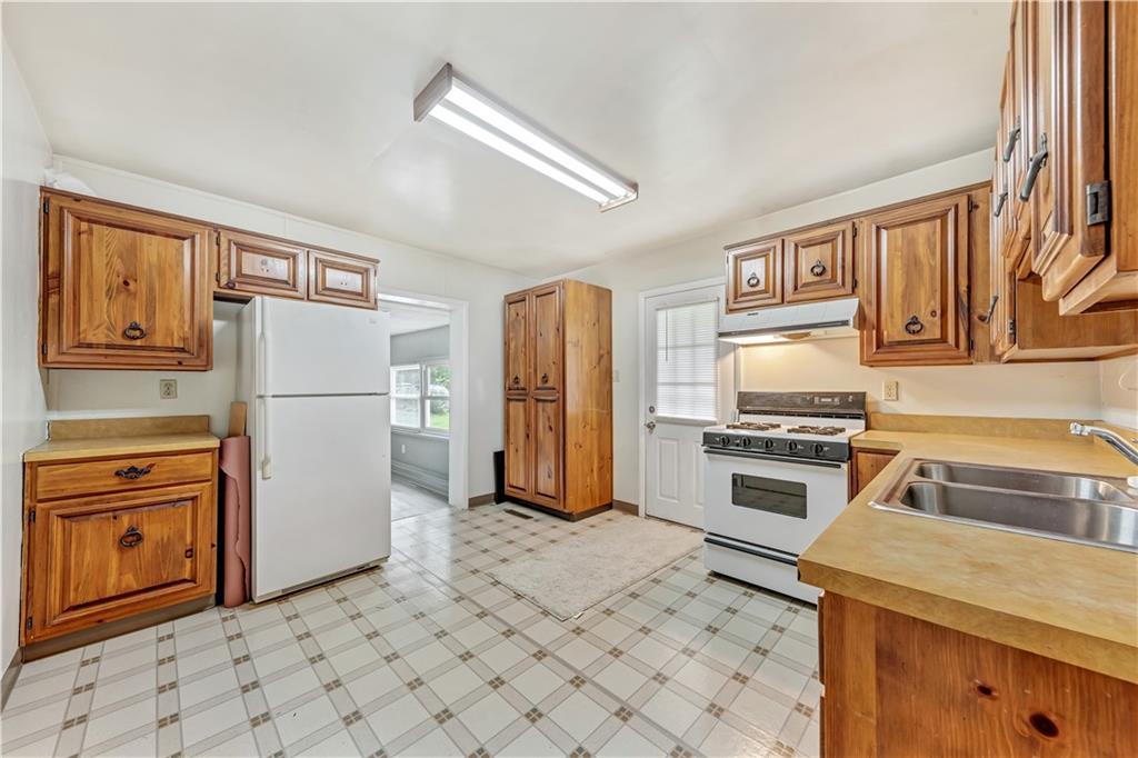 1299 Harvey Run Road Freedom, PA 15042 - Photo 6 of 25 a kitchen with stainless steel appliances a refrigerator sink and stove