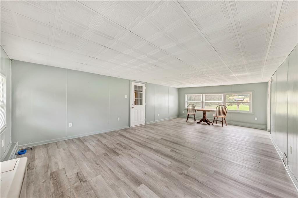 1299 Harvey Run Road Freedom, PA 15042 - Photo 8 of 25 a view of a livingroom with wooden floor and furniture
