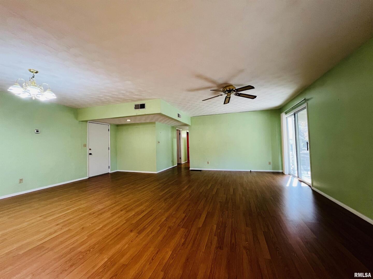 295 Country Acres Road Eldorado, IL 62930 - Photo 22 of 32 an empty room with wooden floor and windows