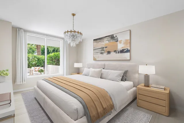 a bedroom with bed and a large window