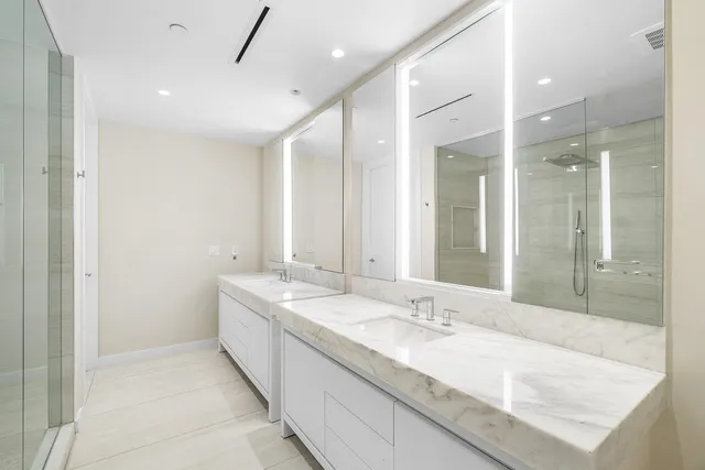 a large bathroom with a granite countertop sink mirror and double