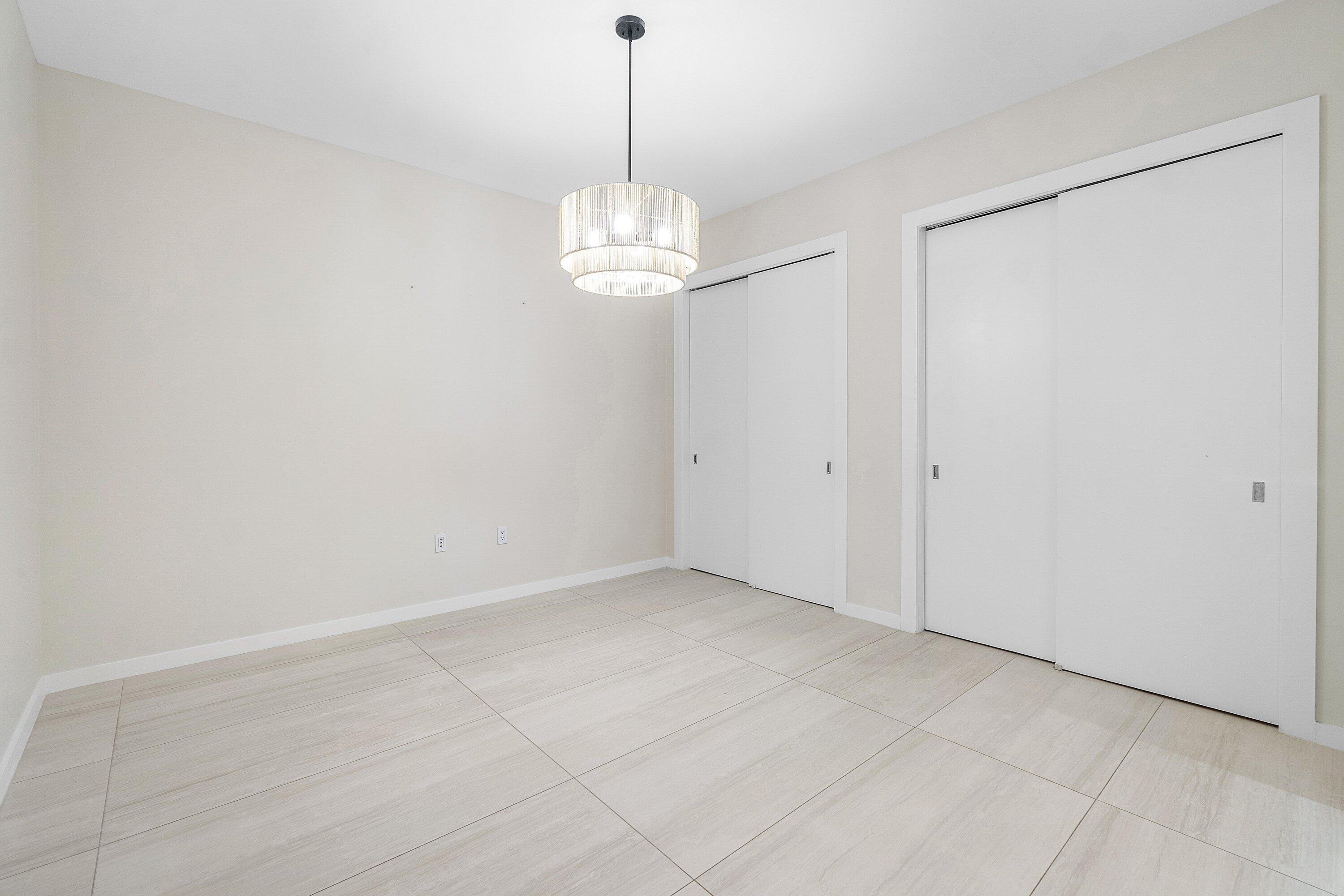200 Southeast Mizner Boulevard, Unit 209 Boca Raton, FL 33432 - Photo 21 of 60 a view of an empty room with a chandelier