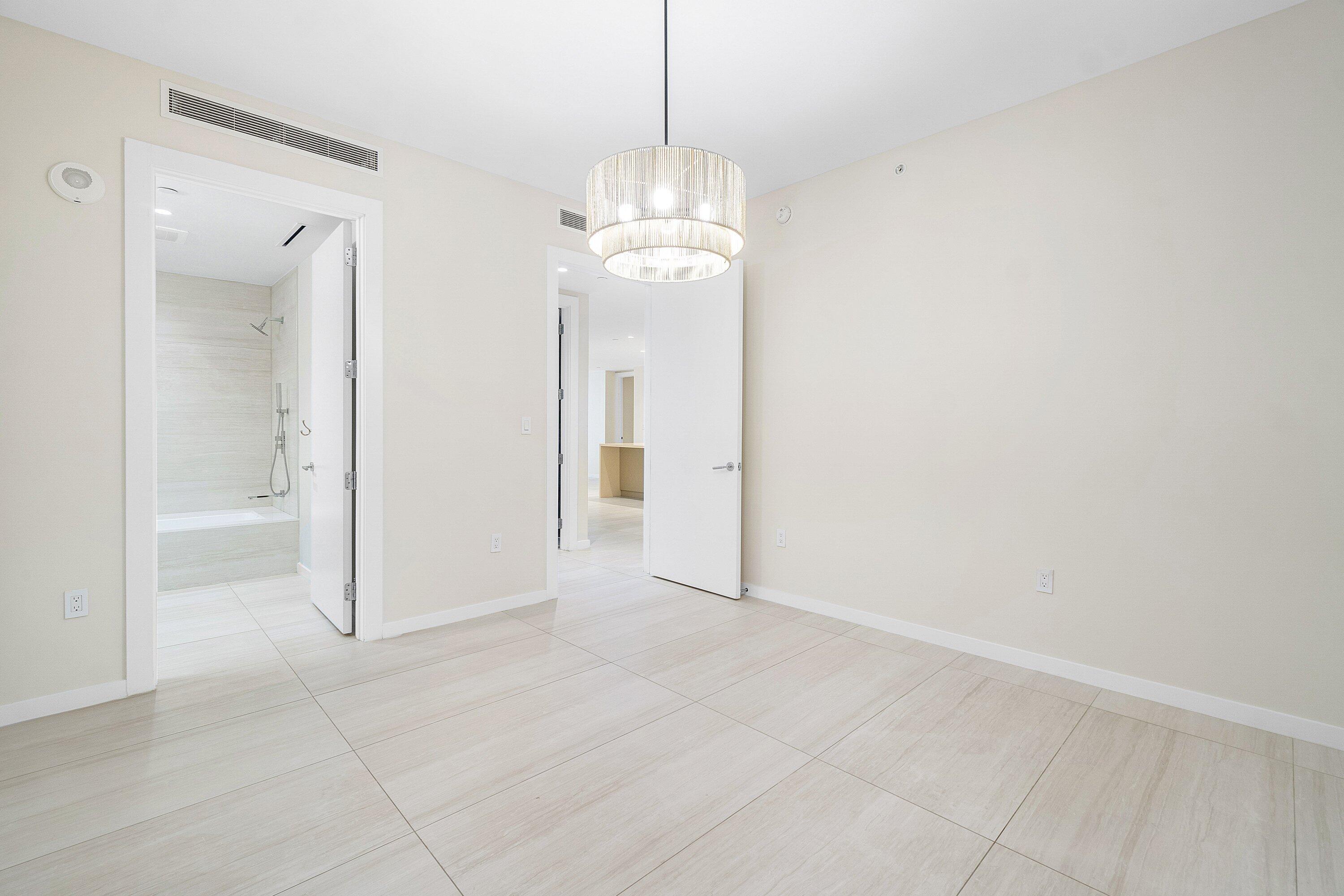 200 Southeast Mizner Boulevard, Unit 209 Boca Raton, FL 33432 - Photo 22 of 60 a view of a chandelier in big room and chandelier fan