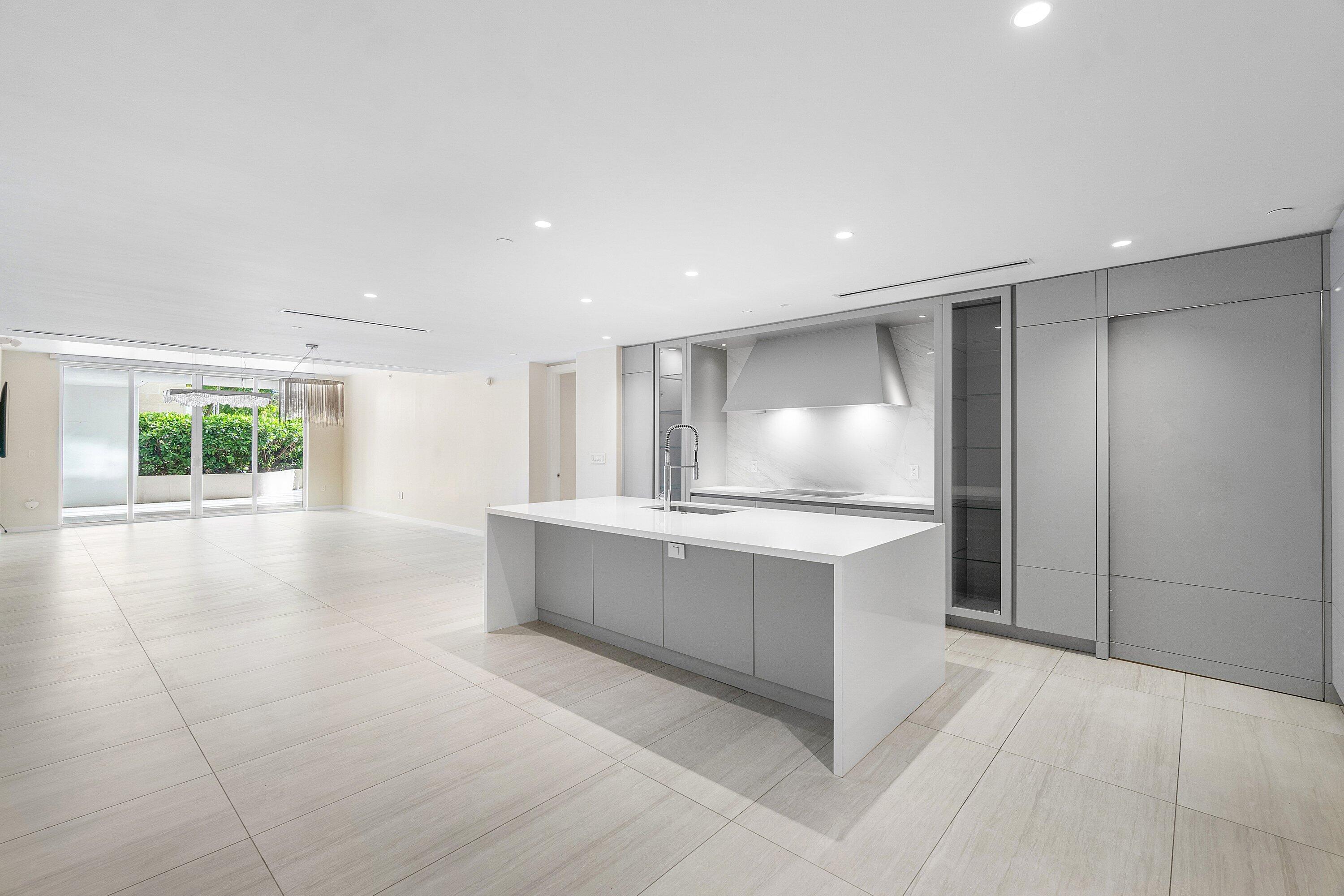 200 Southeast Mizner Boulevard, Unit 209 Boca Raton, FL 33432 - Photo 3 of 60 a large kitchen with kitchen island a sink stainless steel appliances and cabinets