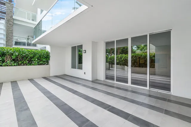 a living room with furniture and large windows