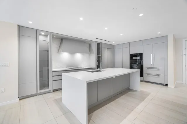 a view of kitchen with cabinets and refrigerator