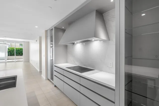 a bathroom with a glass shower door and a sink