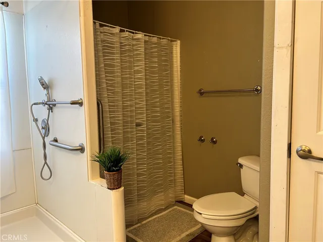 a bathroom with a toilet and shower