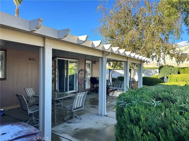 a view of a patio with table and chairs and potted plants