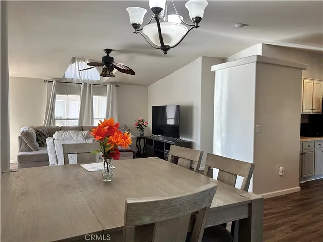 a view of a dining room with furniture and a chandelier