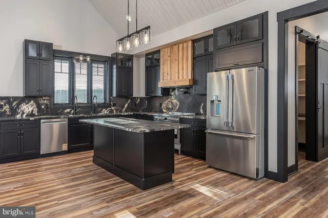 a kitchen with a sink stove and refrigerator