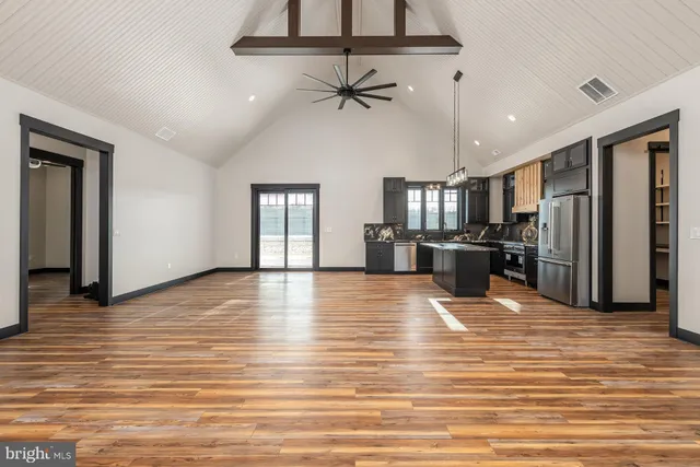 a view of a kitchen with a refrigerator and a ceiling fan
