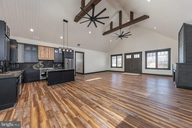 a view of kitchen with stove and cabinets