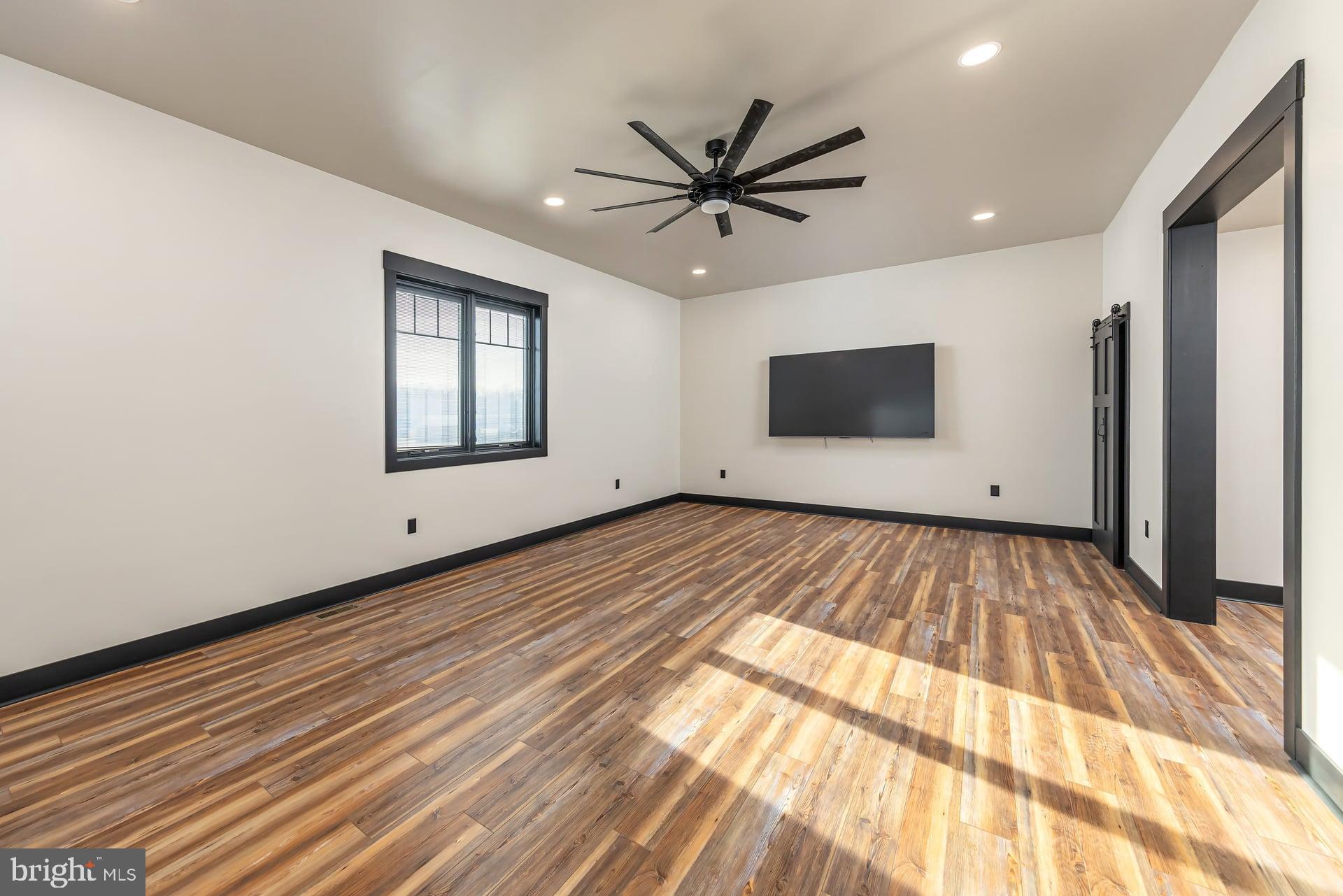 75 Ferrell Road Mullica Hill, NJ 08062 - Photo 17 of 42 a view of an empty room with wooden floor and a window