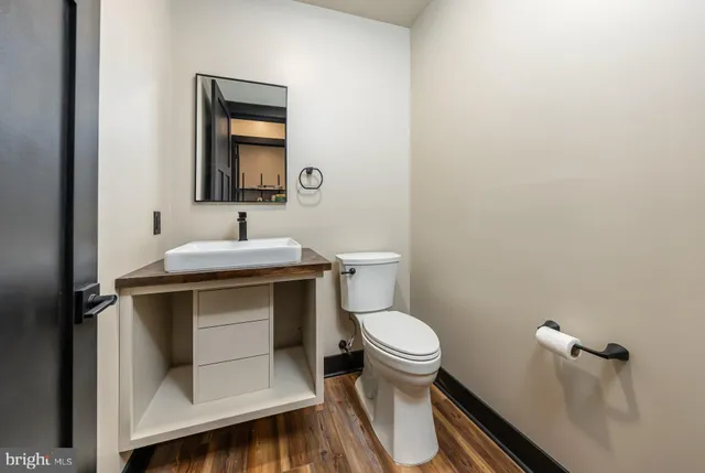 a bathroom with a sink toilet and mirror