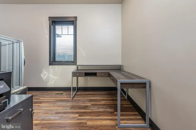 a view of a livingroom with wooden floor and a staircase