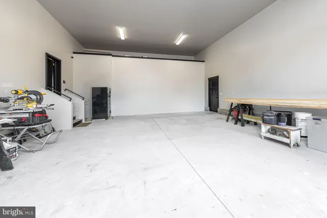 a view of a livingroom with furniture and a garage