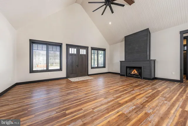 a view of an empty room with window and fireplace