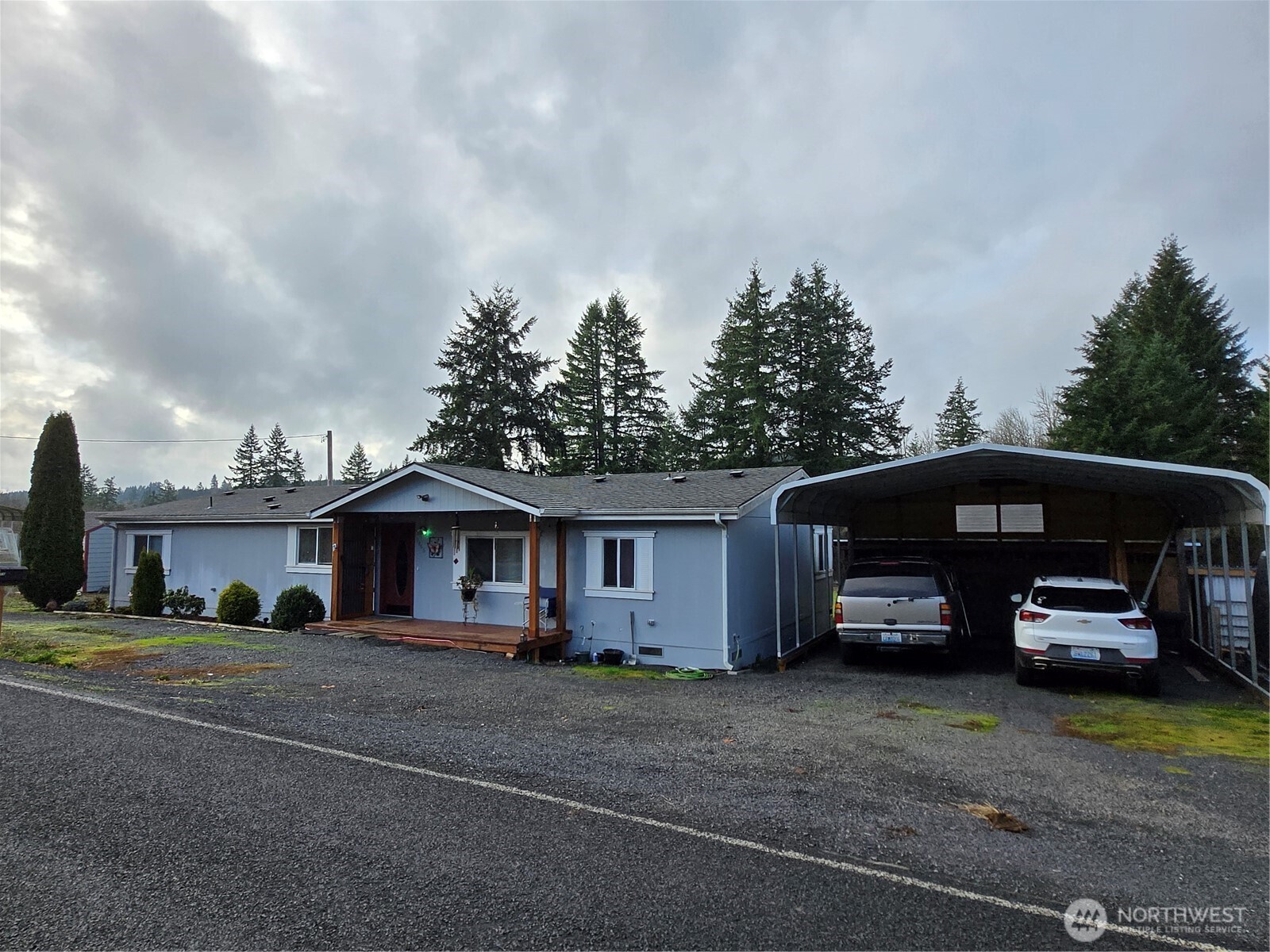 1466 Ferrier Road Winlock, WA 98596 - Photo 1 of 33 a front view of a house with a garden and parking