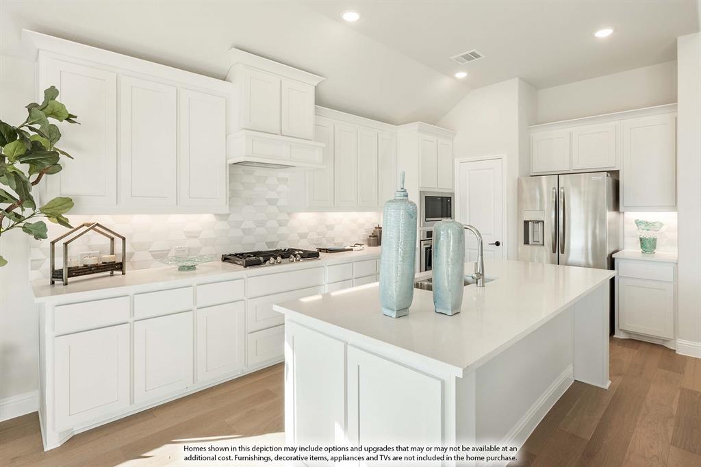 5845 Anning Way Pilot Point, TX 76258 - Photo 16 of 39 a kitchen with stainless steel appliances granite countertop a sink a refrigerator and a white cabinets