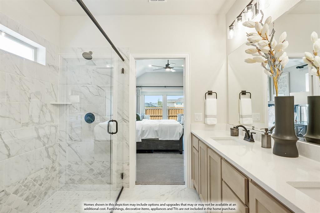 5845 Anning Way Pilot Point, TX 76258 - Photo 24 of 39 a en suite bathroom with a double vanity sink a mirror and shower