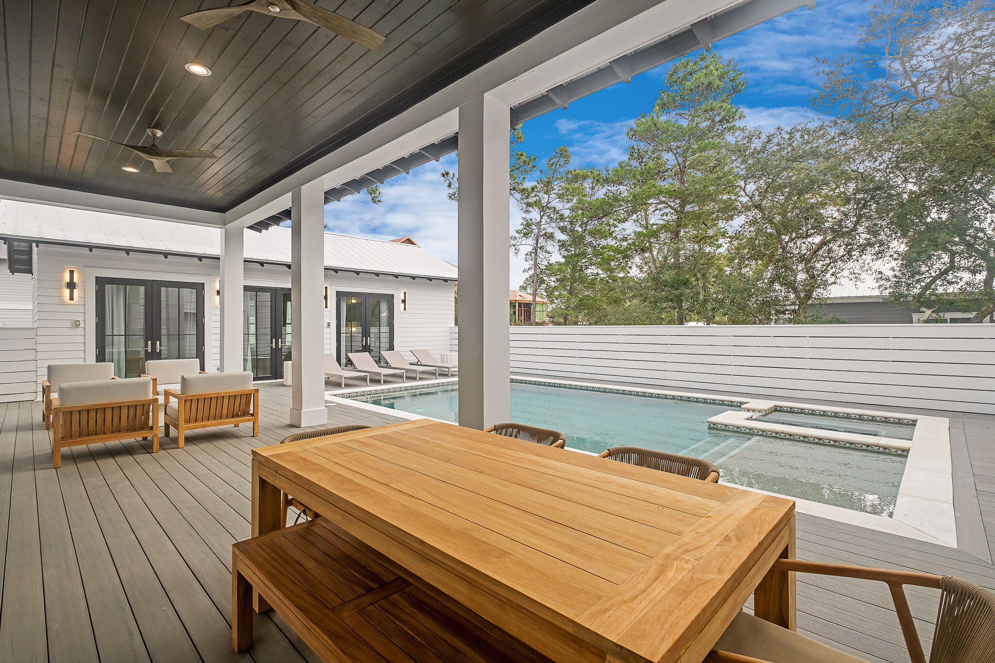 65 South Gulf Drive Santa Rosa Beach, FL 32459 - Photo 11 of 42 a view of a patio with table and chairs with wooden floor and fence