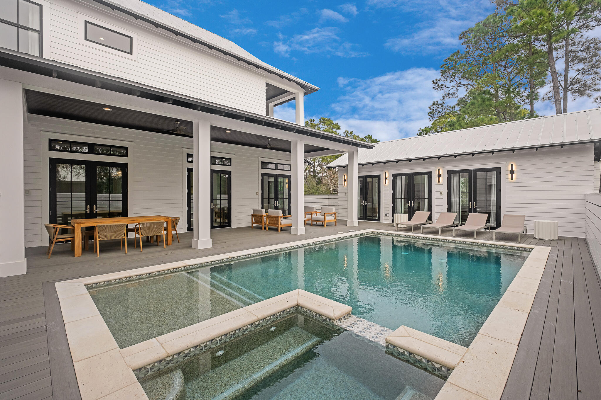 65 South Gulf Drive Santa Rosa Beach, FL 32459 - Photo 12 of 42 a view of a patio with couches table and chairs with wooden floor and fence